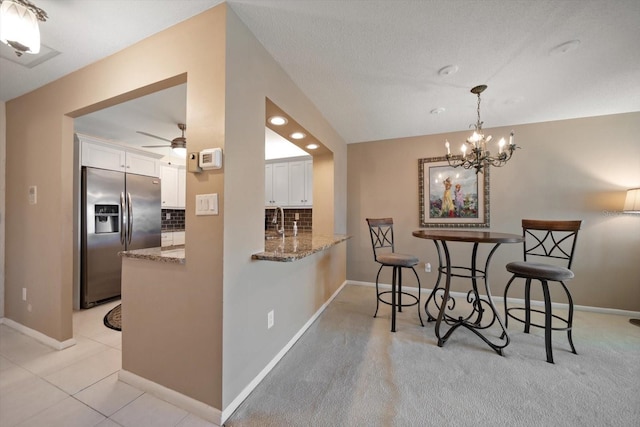 dining area with light tile patterned floors, recessed lighting, ceiling fan with notable chandelier, and baseboards