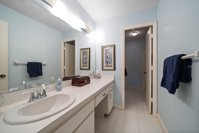 bathroom featuring baseboards, vanity, and tile patterned flooring