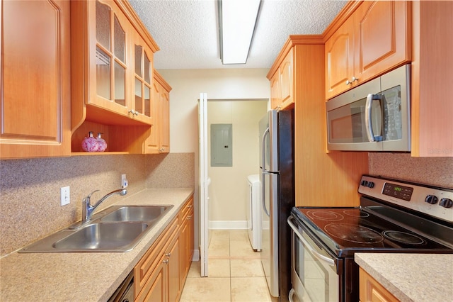 kitchen with electric panel, stainless steel appliances, light countertops, and a sink