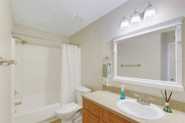 bathroom with shower / bath combo with shower curtain, toilet, a textured ceiling, and vanity