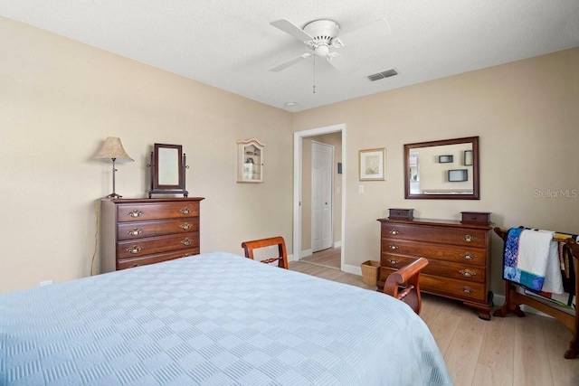 bedroom with visible vents, ceiling fan, baseboards, and light wood-style floors