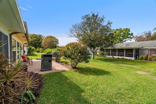 view of yard featuring a patio area and a sunroom