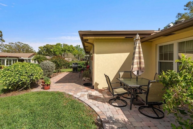 view of patio / terrace featuring outdoor dining area and a grill