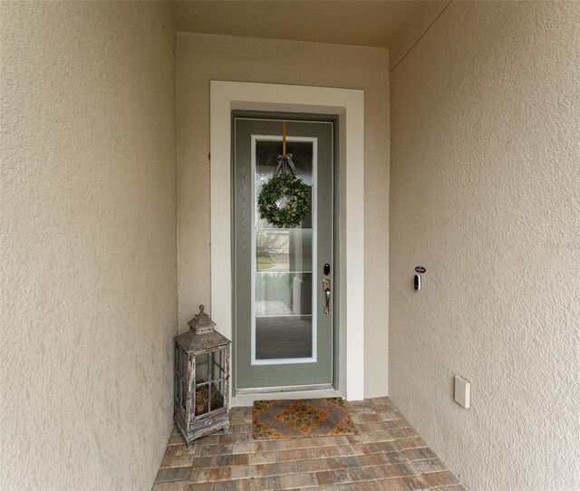 doorway to property with stucco siding