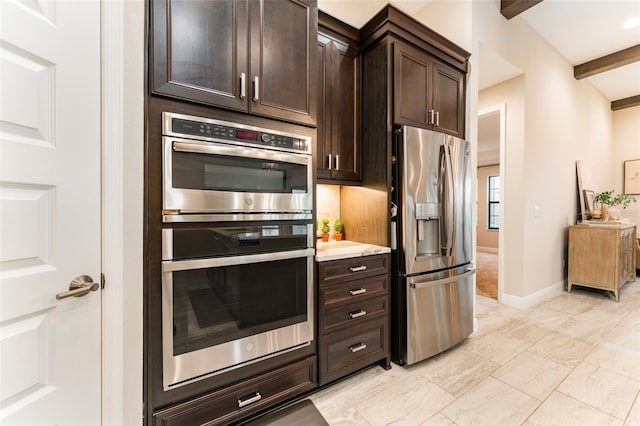 kitchen with baseboards, beam ceiling, light countertops, dark brown cabinets, and appliances with stainless steel finishes