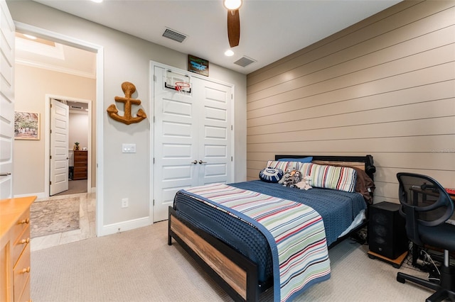 bedroom with baseboards, visible vents, a closet, and light carpet