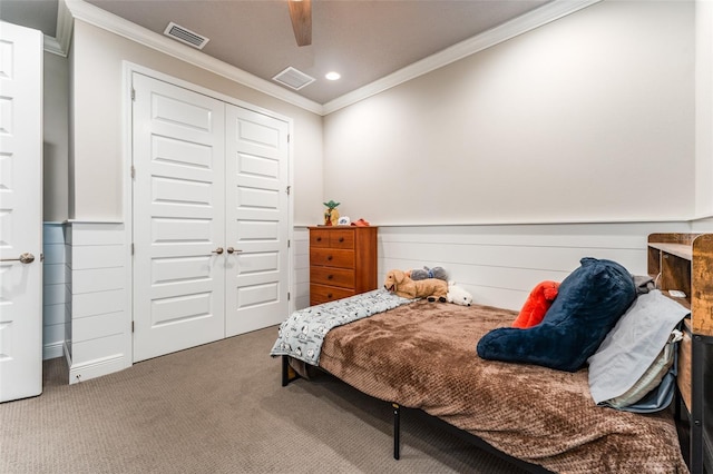 carpeted bedroom featuring recessed lighting, visible vents, a closet, and crown molding