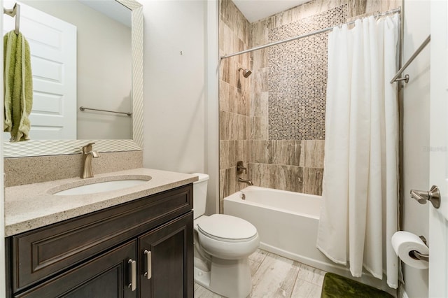 bathroom featuring shower / bath combo with shower curtain, toilet, and vanity