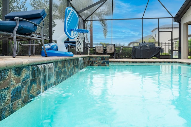 view of pool with grilling area, glass enclosure, and a fenced in pool