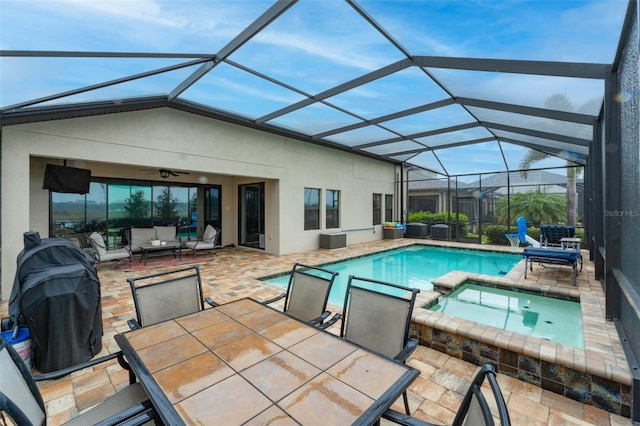 view of swimming pool featuring a ceiling fan, a pool with connected hot tub, a patio, outdoor lounge area, and outdoor dining area