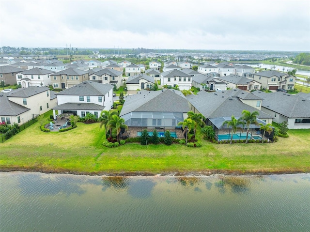 drone / aerial view with a residential view and a water view