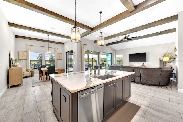 kitchen with a sink, dishwasher, open floor plan, and a healthy amount of sunlight