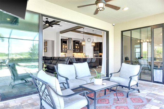 view of patio featuring ceiling fan, an outdoor living space, and a sink