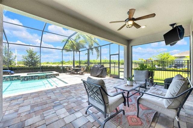 view of patio featuring an outdoor living space, glass enclosure, outdoor dining area, a pool with connected hot tub, and a ceiling fan