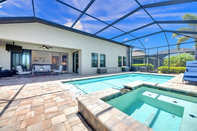 view of pool with a patio, glass enclosure, a ceiling fan, and a pool with connected hot tub