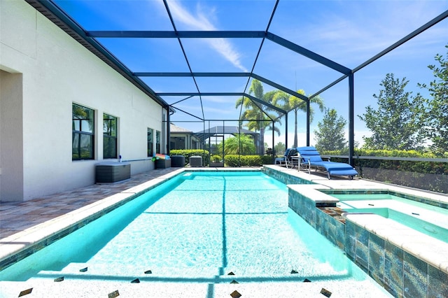 view of swimming pool with a pool with connected hot tub and a patio area
