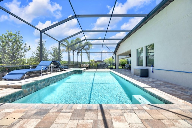 view of pool featuring a lanai, central AC unit, a patio, and a pool with connected hot tub
