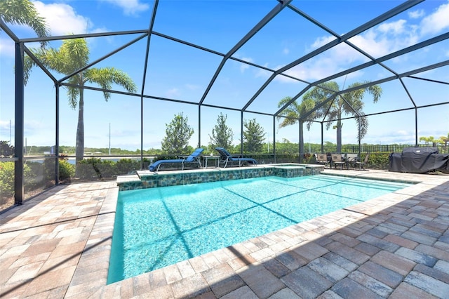view of swimming pool with a pool with connected hot tub, glass enclosure, and a patio area