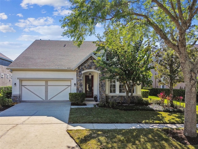 view of front of home with stone siding, driveway, a front yard, and a garage