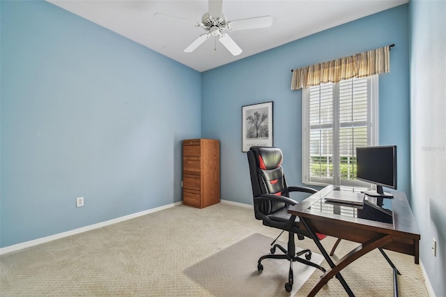 carpeted home office featuring ceiling fan and baseboards