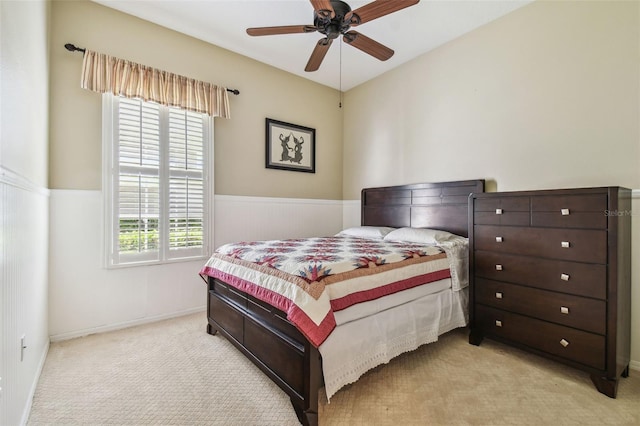 bedroom with light carpet, baseboards, and ceiling fan