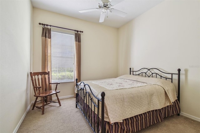 carpeted bedroom featuring baseboards and a ceiling fan