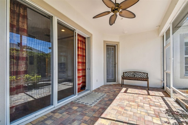 exterior space with stucco siding, a patio area, and ceiling fan