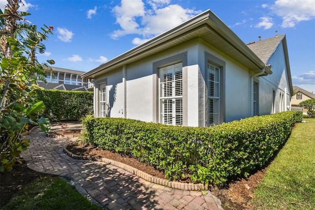 view of side of home with stucco siding