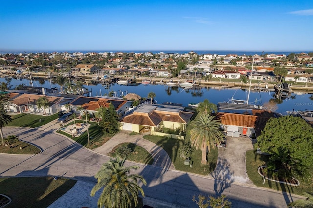 drone / aerial view featuring a residential view and a water view