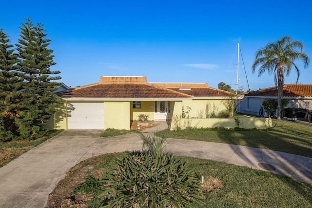 view of front of property with a garage, driveway, and stucco siding