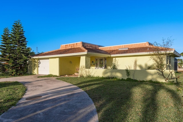 view of front of property featuring stucco siding, a front yard, concrete driveway, and an attached garage