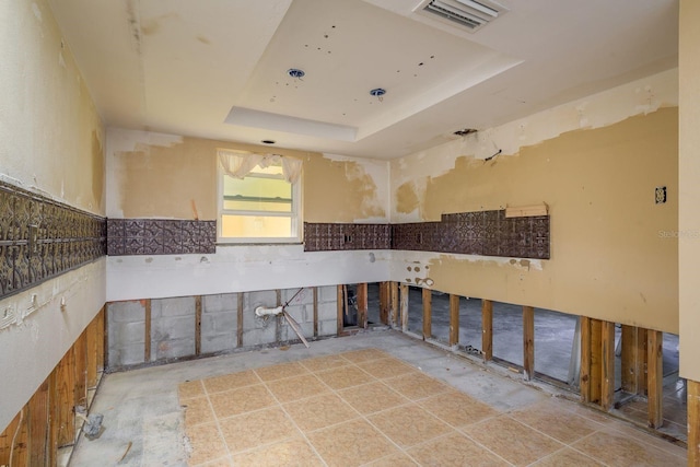 kitchen with a tray ceiling and visible vents