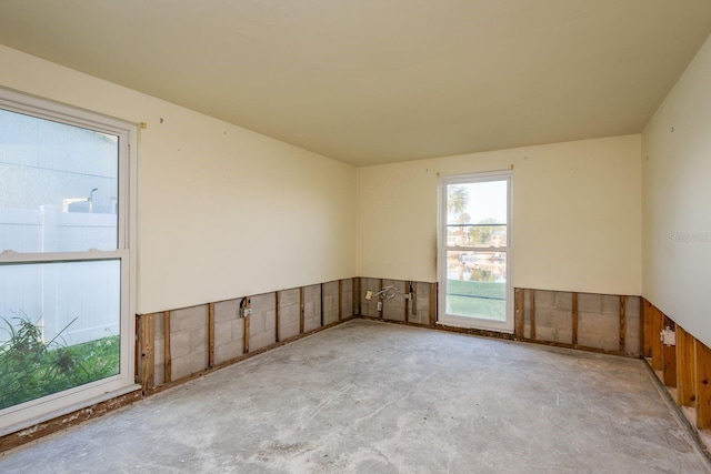 unfurnished room featuring unfinished concrete floors