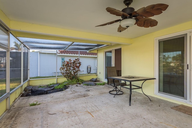 view of patio featuring ceiling fan and a lanai