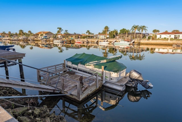 dock area with a water view and boat lift