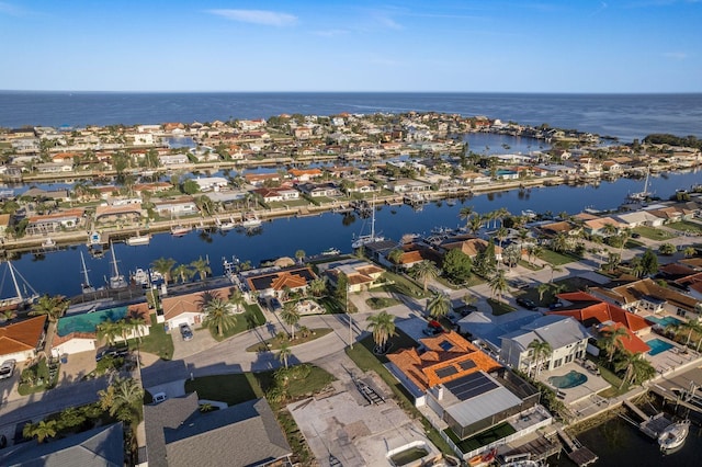 drone / aerial view featuring a residential view and a water view