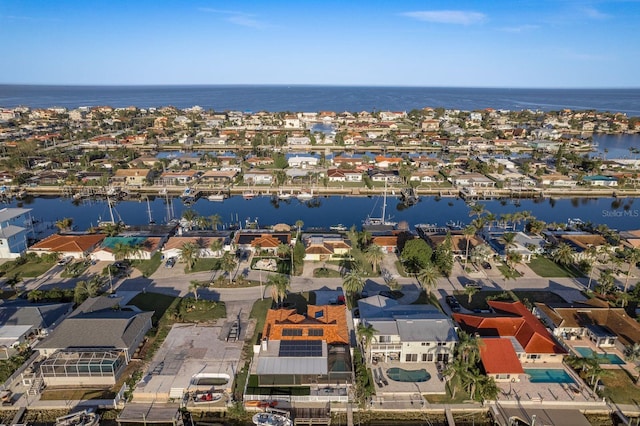 drone / aerial view featuring a water view and a residential view