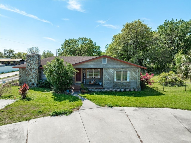 bungalow-style house with covered porch, a front yard, and fence