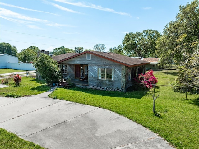 bungalow-style home featuring a front yard and fence