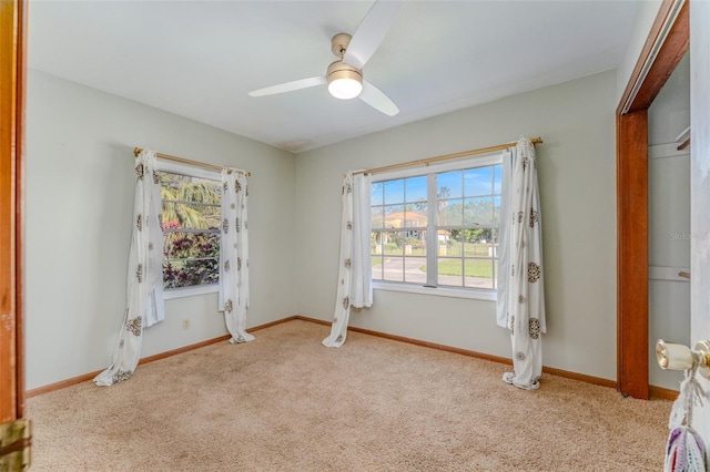 unfurnished bedroom with ceiling fan, carpet, and baseboards