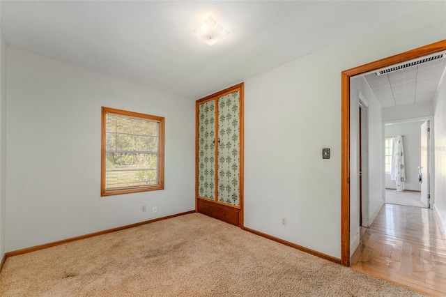 empty room with visible vents, baseboards, and carpet floors