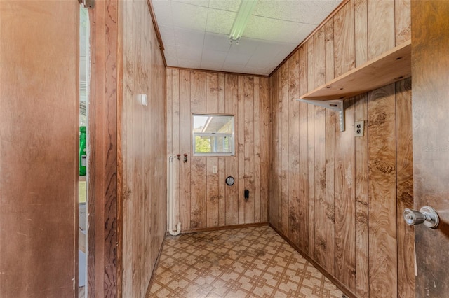 interior space featuring tile patterned floors and wooden walls