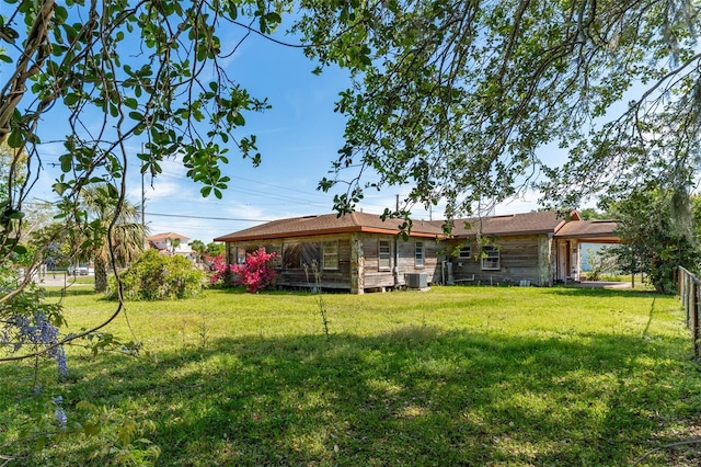view of yard featuring central AC and fence