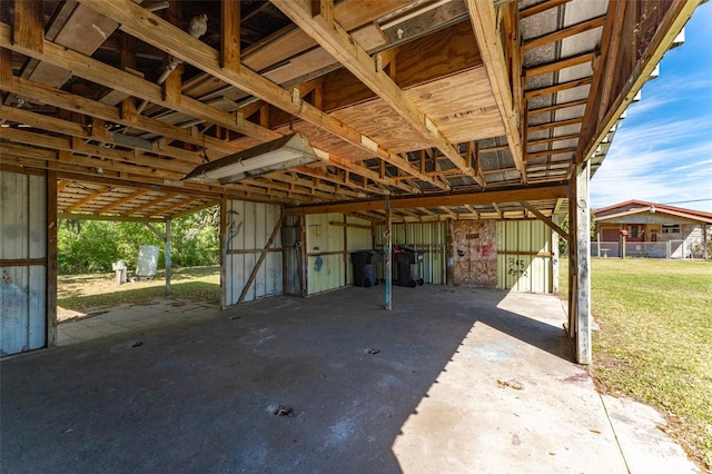 view of patio with an attached carport, an outdoor structure, and an exterior structure