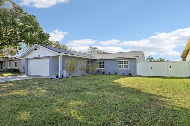 view of front of house with a front lawn, a gate, a garage, and stucco siding