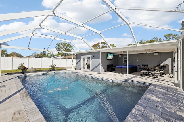 view of pool featuring a ceiling fan, a fenced backyard, french doors, an outdoor hangout area, and a patio area