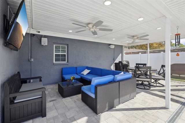 view of patio / terrace with a ceiling fan, outdoor dining area, fence, and an outdoor hangout area