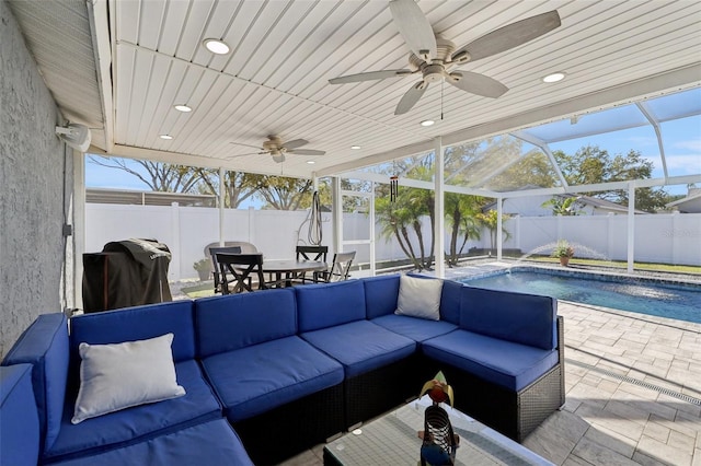 view of patio featuring outdoor lounge area, glass enclosure, a fenced backyard, and ceiling fan