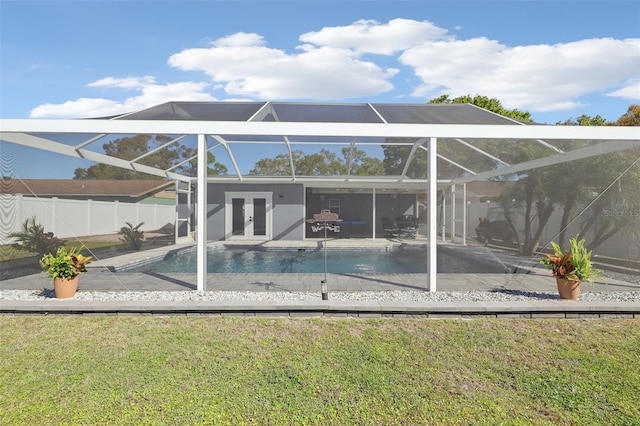 back of house featuring glass enclosure, a patio, a fenced in pool, fence, and french doors