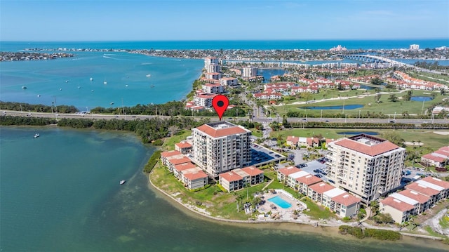 birds eye view of property with a view of city and a water view